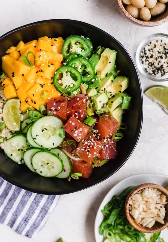 With marinated tuna, brown rice, avocado, cucumber, mango, macadamias and scallions, this Hawaiian style quick-cook Ahi Poke Bowl is perfect for hot summer nights. 