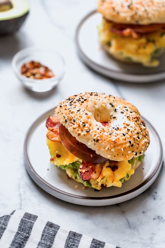 Bacon, egg and avocado on a bagel is my favorite breakfast sandwich made with scrambled eggs, center cut bacon and sliced tomatoes on my homemade bagels.