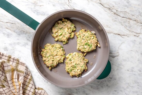 These easy zucchini fritters are crunchy, cheesy, and full of Mediterranean flavor! Serve as a summer side dish, appetizer, or light meal. Fry pumpkin in a frying pan.