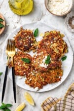 Plate of zucchini fritters with feta and mint.