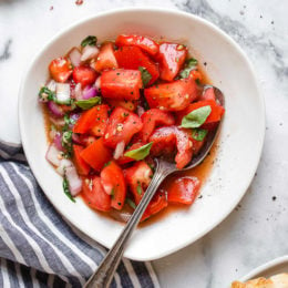 Ripe, end-of-summer garden tomatoes make the best, juiciest tomato salad, perfect served with a rustic loaf of bread!