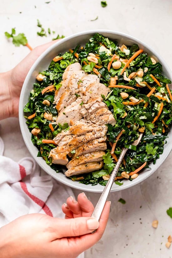 Houston’s (Lightened-Up) Kale Salad with Peanut Vinaigrette is satisfying, made with a combo of grilled chicken, kale, cabbage, carrots, peanuts, scallions, cilantro and mint tossed in a light peanut-sesame dressing. 