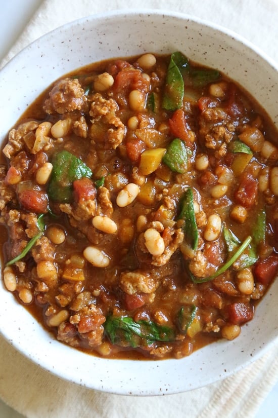Turkey Pumpkin Chili is the perfect Fall dish made with ground turkey, tomatoes, canned pumpkin, white beans and spinach.