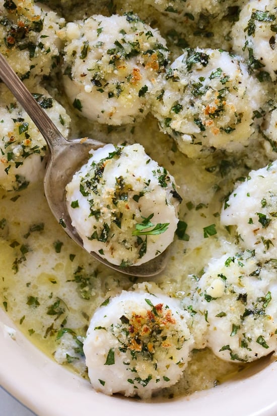 These quick and easy baked sea scallops are topped with panko and Parmesan in a simple lemon-butter sauce.