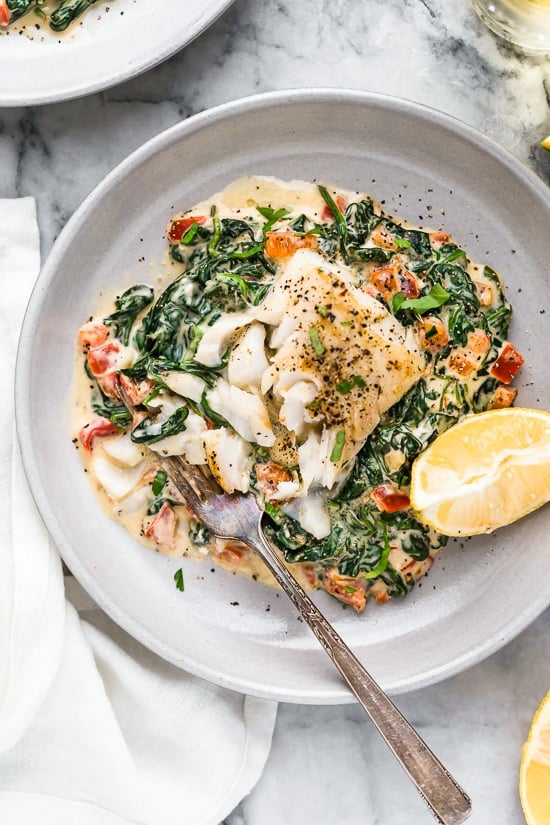 This easy Fish Florentine recipe, made with a pan seared firm white fish served on a creamy bed of spinach feels like something you would order out in a fancy restaurant!