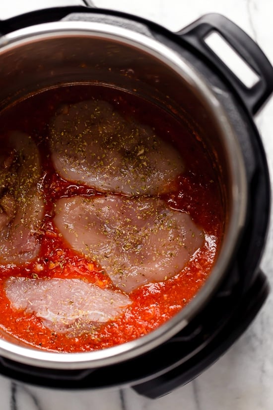 Chicken breasts over tomato sauce in the Instant Pot