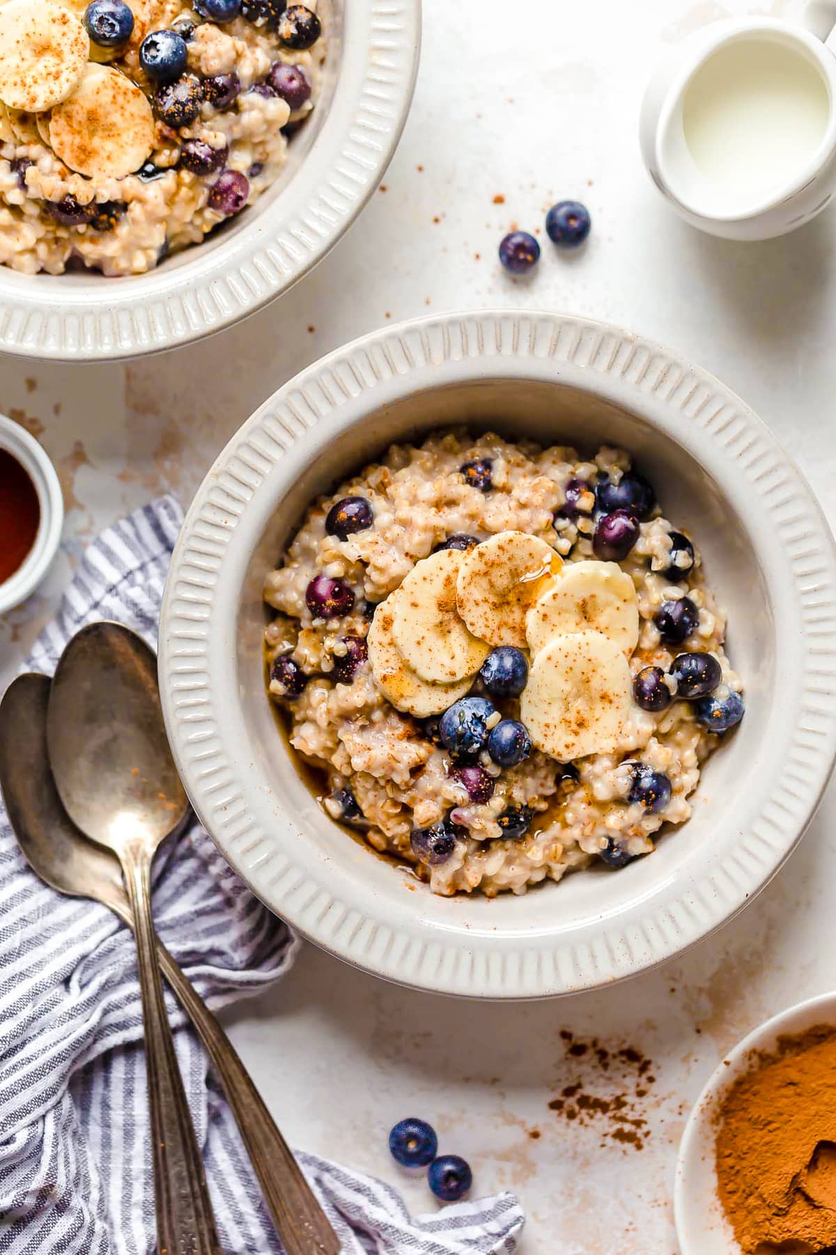 Overhead view of a bowl of steel cut oats with blueberries and bananas