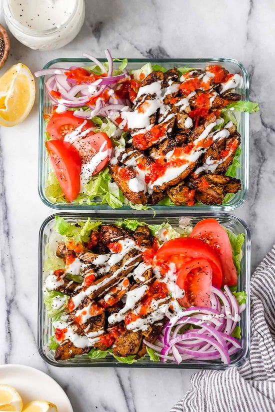 Halal Food Cart inspired chicken served over a big salad of lettuce and tomatoes drizzled with a yummy white sauce.
