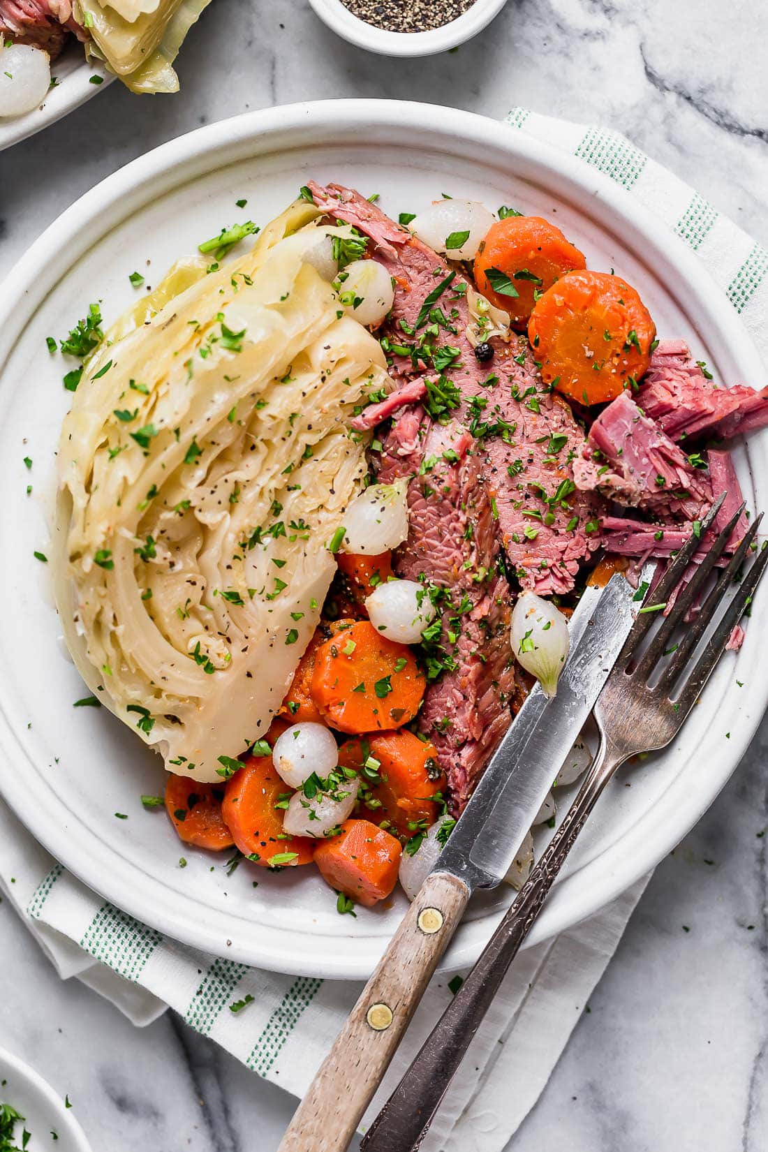 A plate of Instant Pot corned beef with cabbage, carrots and onions