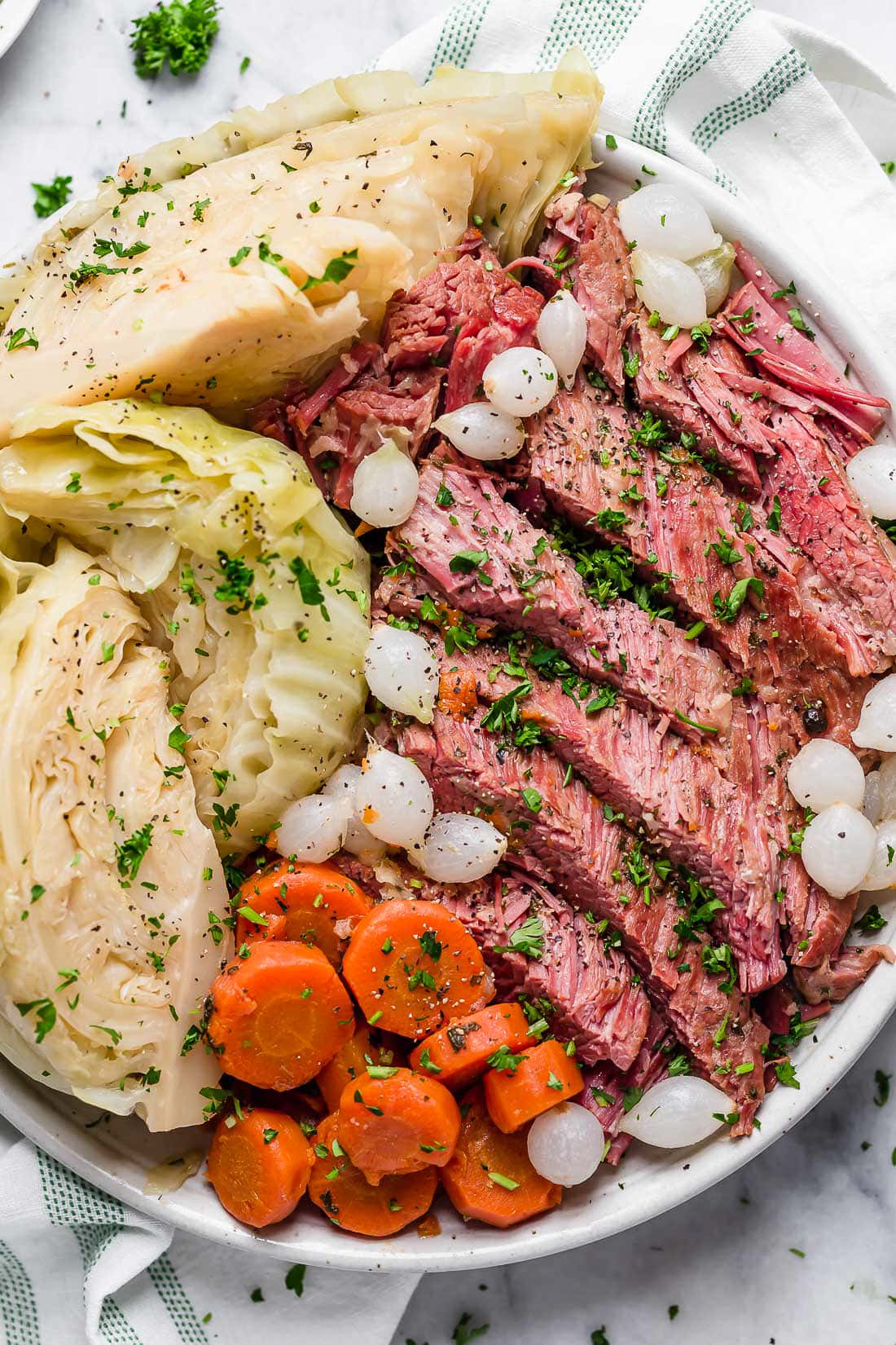 A plate of corned beef, cabbage, carrots, and onions