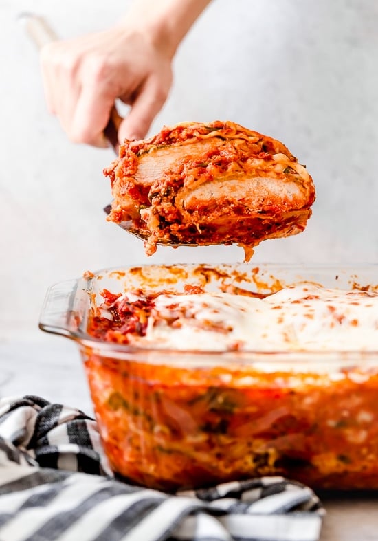 A spatula serving chicken parmesan lasagna