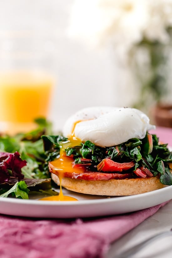 I love this lighter take on Eggs Benedict made with Canadian bacon, Swiss chard and poached eggs on a whole wheat English muffin. Perfect for breakfast or brunch!