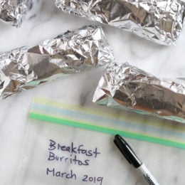These freezer breakfast burritos, stuffed with scrambled eggs, scallions, bell pepper, bacon and cheese, are a great way to start the day! Make them ahead and freeze them for meal prep so you can have them ready any day of the week.