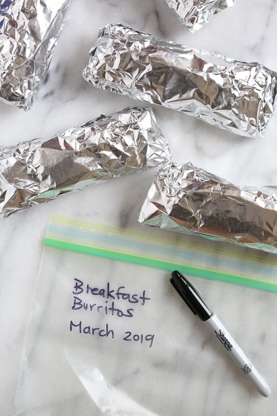These freezer breakfast burritos, stuffed with scrambled eggs, scallions, bell pepper, bacon and cheese, are a great way to start the day! Make them ahead and freeze them for meal prep so you can have them ready any day of the week. 