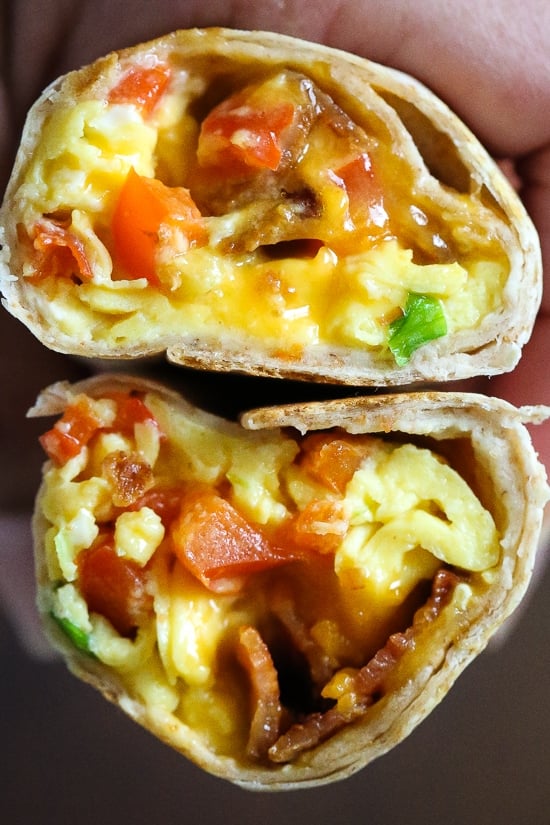 These freezer breakfast burritos, stuffed with scrambled eggs, scallions, bell pepper, bacon and cheese, are a great way to start the day! Make them ahead and freeze them for meal prep so you can have them ready any day of the week. 