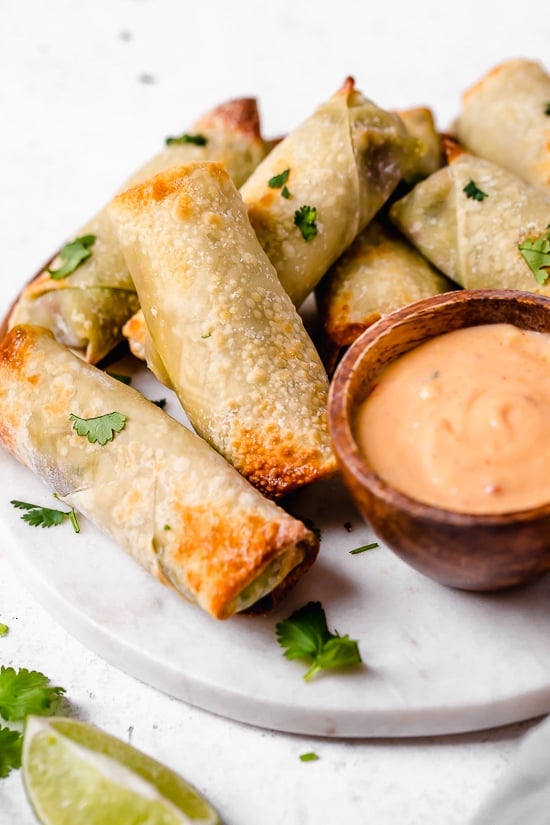 These Avocado Egg Rolls are inspired by the Cheesecake Factory egg rolls, only healthier because they are not fried. An easy air fryer recipe or bake them in the oven!