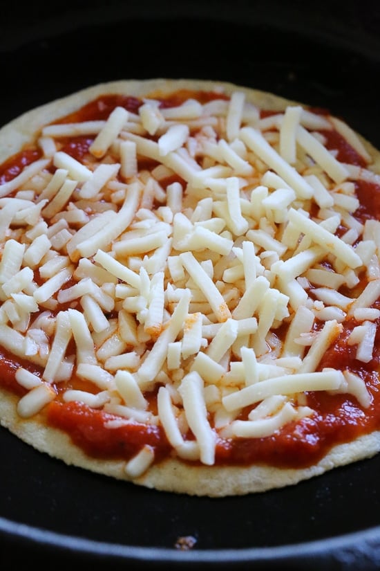 I'm obsessed with this Super-Quick Cast-Iron Pizza technique made with tortillas.This combined stove top and oven recipe comes out just like Domino's or any bar thin crust pizza!