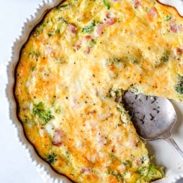 This low-carb Crustless Ham and Cheese Quiche is light and delicious, perfect for breakfast or brunch (or even a light dinner)! Made with a leftover ham or ham steak, broccoli and Swiss Cheese.