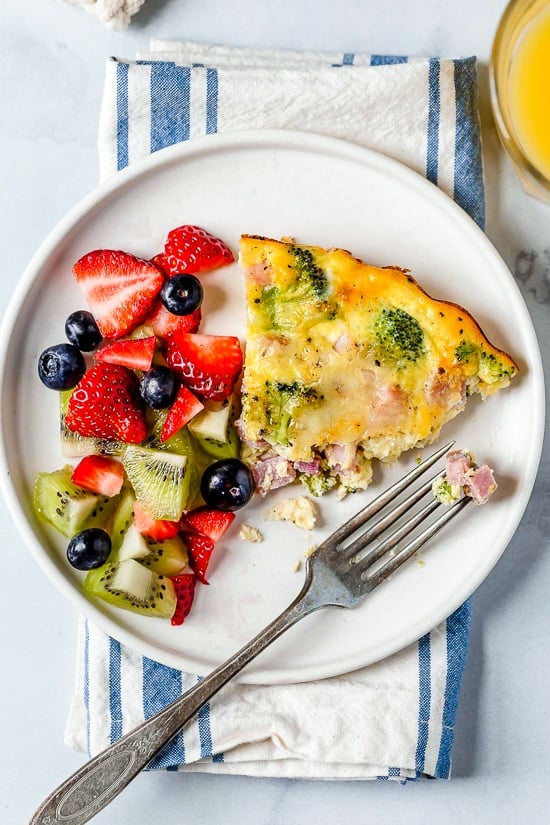 This low-carb Crustless Ham and Cheese Quiche is light and delicious, perfect for breakfast or brunch (or even a light dinner)! Made with a leftover ham or ham steak, broccoli and Swiss Cheese.
