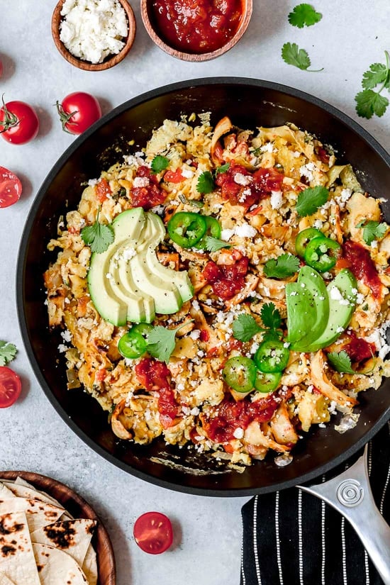 Migas is a popular Tex Mex egg dish made with chopped corn tortillas, cheese, tomatoes, jalapeños, and onions. I serve it plated with tortillas on the side, but they can also be wrapped in a tortilla, taco style.