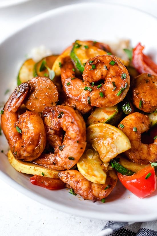 This fast and easy Air Fryer Cajun Shrimp recipe is a meal-in-one, made with shrimp, sausage, and lots of colorful vegetables such as zucchini, yellow squash and bell peppers.