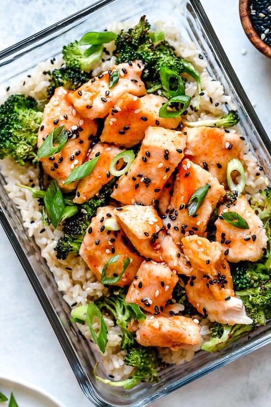 Doubles as a main dish, this easy meal prep honey sriracha chicken dish is made in a baking sheet and ready in no time!