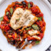 This healthy Mediterranean Sea Bass is smothered in a piquant, healthy, Mediterranean-inspired sauce made from tomatoes, white wine, fennel and olives.