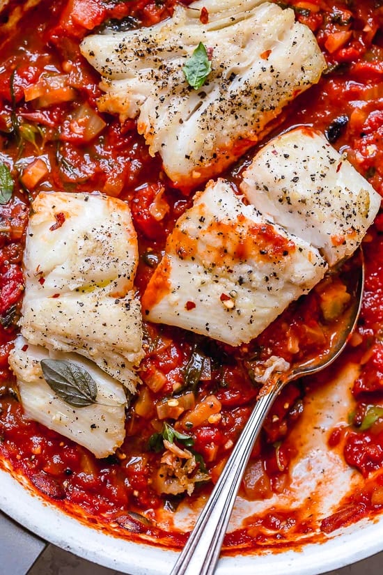 This healthy Mediterranean Sea Bass is smothered in a piquant, healthy, Mediterranean-inspired sauce made from tomatoes, white wine, fennel and olives.