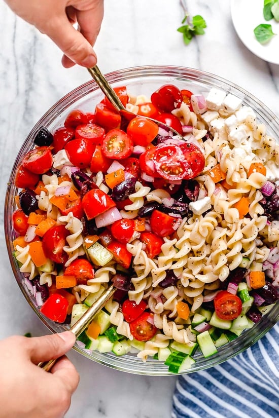 This Greek Pasta Salad is light and fresh, loaded with garden tomatoes, bell peppers and cucumbers tossed in a homemade Greek dressing with Kalamata olives and Feta cheese. Perfect for summer parties or potlucks!