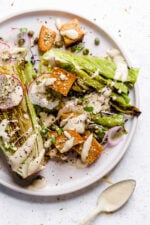 Vegan Caesar salad on plate with creamy dressing.