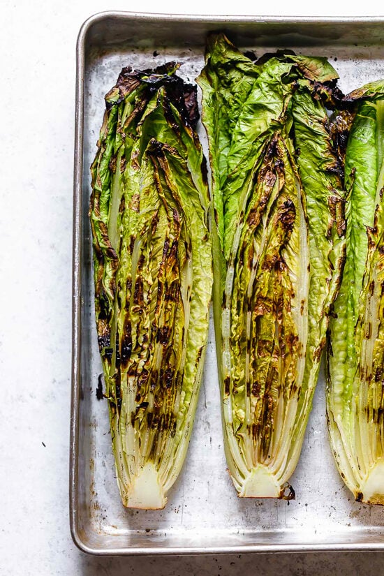Grilled romaine makes this salad a standout! You’ll love the creamy vegan Caesar dressing, which is made with raw cashews instead of egg. Grilled romaine on sheet pan.