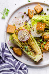 Plate of vegan Caesar salad with grilled romaine.