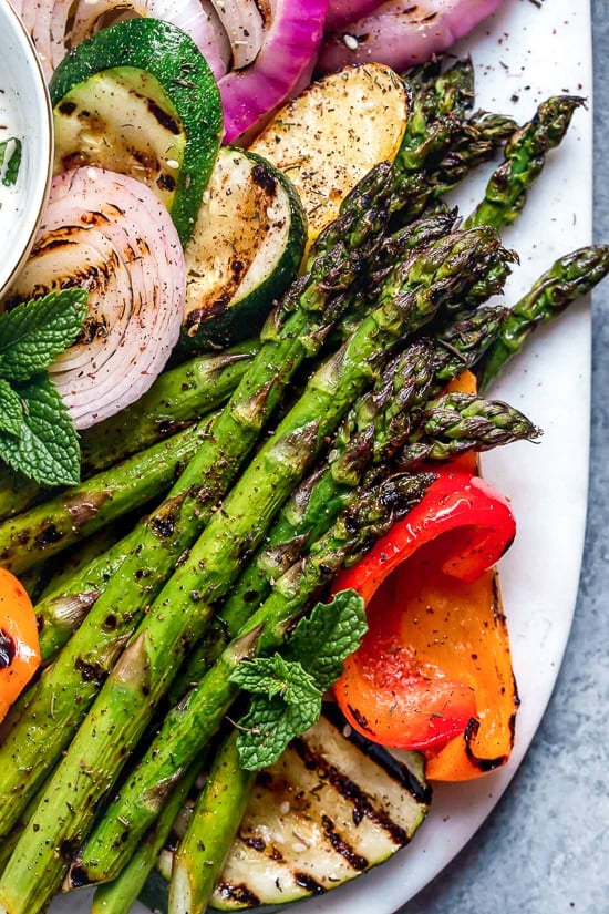 This beautiful, Grilled Vegetable Platter with Yogurt Mint Sauce is so colorful. An easy summer side dish made with asparagus, zucchini, squash, red onion and bell peppers.
