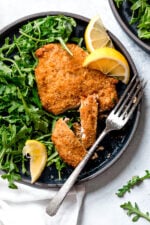 Crisp, golden, delicious Air Fryer Chicken Milanese with Baby Arugula and lemon wedges is one of my favorite dinner recipes!