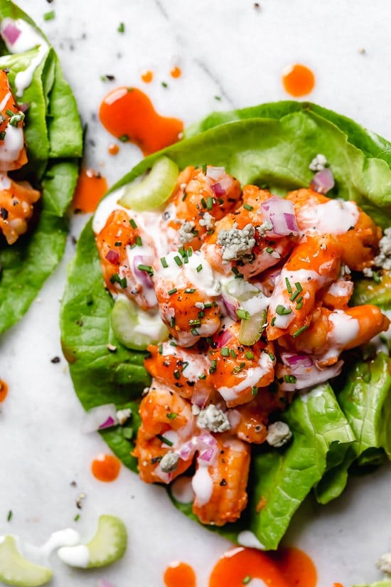 These easy, low-carb Buffalo Shrimp Lettuce Wraps are spicy, light and delicious topped with celery and blue cheese or ranch dressing.
