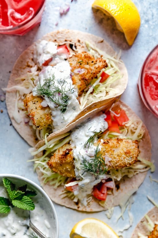 Tzatziki Fish Tacos have a Greek twist! Made with breaded white fish filet topped with mint tzatziki sauce.
