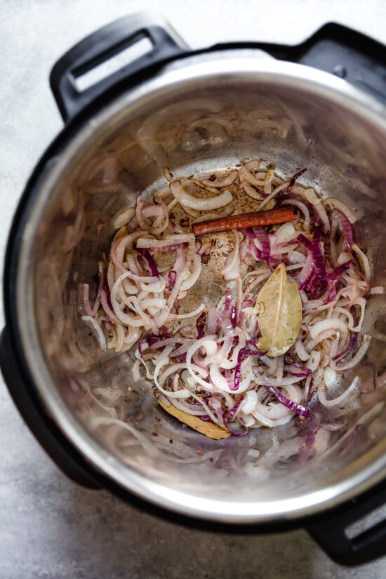 Sliced onion and spices in an Instant Pot