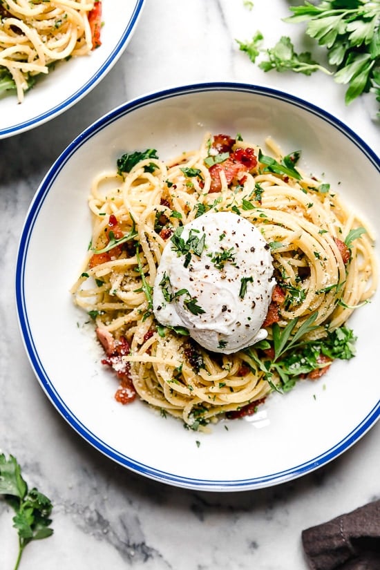 Spaghetti Carbonara is an Italian pasta dish made with bacon or pancetta, egg, black pepper and a blend of Pecorino Romano and Parmigiano-Reggiano.