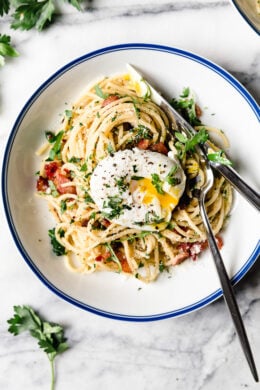 Spaghetti Carbonara is an Italian pasta dish with creamy egg, diced bacon, grated cheese, and copious amounts of black pepper–a Roman dish reminiscent of an American breakfast.