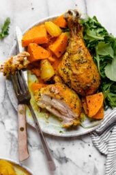 Caramelized sweet potatoes and shallots are the bed for roasted chicken thighs and legs that come together in this one-pot healthy chicken dinner.