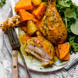Caramelized sweet potatoes and shallots are the bed for roasted chicken thighs and legs that come together in this one-pot healthy chicken dinner.