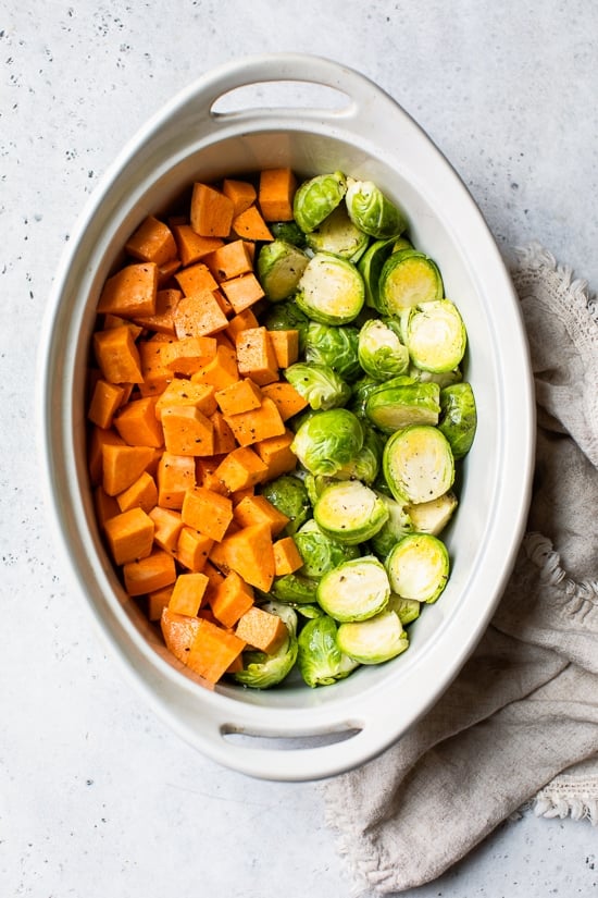 baking dish with sweet potatoes and brussels sprouts