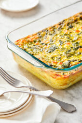 This easy Breakfast Casserole recipe is made with eggs, spinach, tomatoes and Feta cheese and only takes a few minutes to whip up. You can make it ahead of time, so it’s the perfect breakfast egg casserole for Christmas morning or any day!