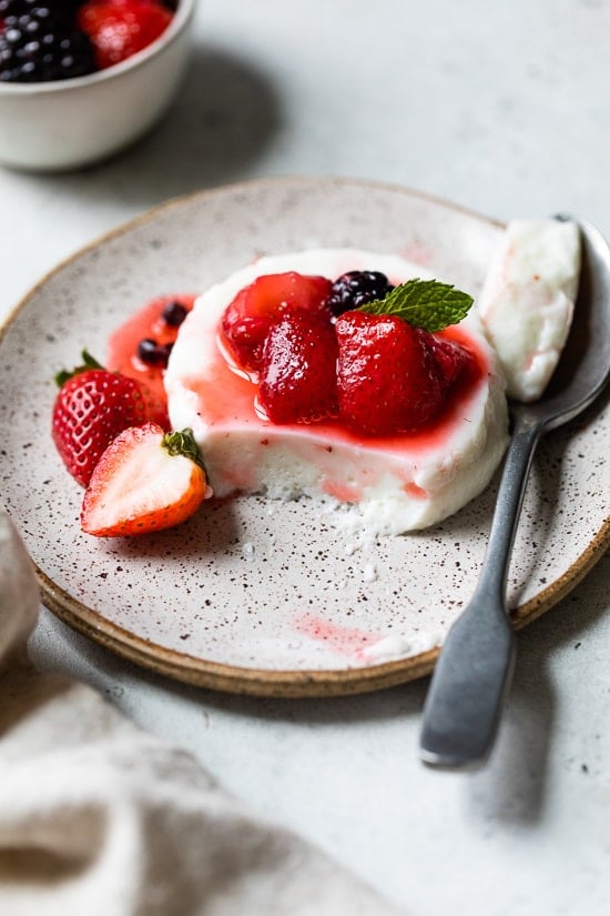 This simple Yogurt Panna Cotta is the perfect smooth, creamy dessert. The cool tang of yogurt pairs perfectly with fresh berries. To macerate the berries simple mix them with a little sugar and let them sit.