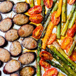 Kielbasa Veggie Sheet Pan Dinner is made with turkey kielbasa, asparagus, tomatoes and bell peppers cooked all on one pan, easy cleanup! It's also Keto, Whole30, Low Carb and Gluten-free.