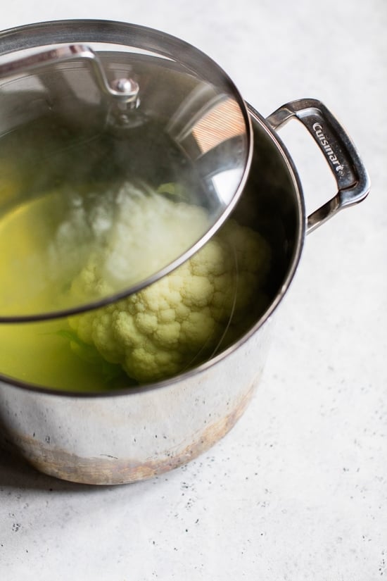 Boiling cauliflower in a large pot.