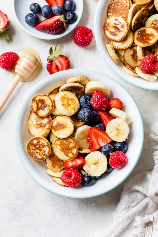 Mini Pancake Cereal is the latest Tiktok trend, so versatile you can serve them with anything you want! I made them healthier with my banana pancake recipe and topped them with tons of fresh fruit.
