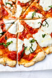Easy Margherita Pizza made from scratch with my yeast-free, thin crust pizza dough topped with a simple raw tomato sauce, fresh mozzarella cheese, and basil.