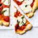 Easy Margherita Pizza made from scratch with my yeast-free, thin crust pizza dough topped with a simple raw tomato sauce, fresh mozzarella cheese, and basil.