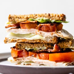 A classic Turkey Club sandwich made healthy, piled high with turkey breast, bacon, lettuce, and tomato on whole grain bread, the perfect easy lunch.
